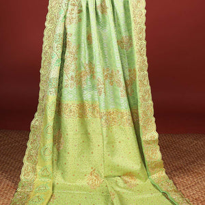 Green silk saree of ogee design with stonework, self curve border of peacock design & grand pallu embedded with stones