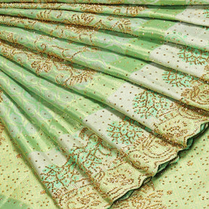 Green silk saree of ogee design with stonework, self curve border of peacock design & grand pallu embedded with stones