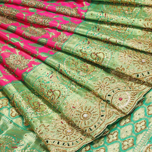Hot pink silksaree with floral & paisley jacquard design, contrast turquoise cut work border & pallu, all-over stonework