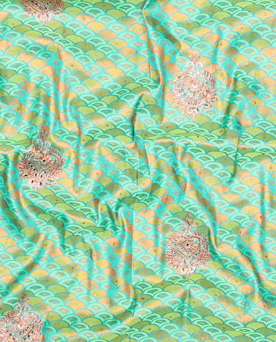Green embossed vastrakala silksaree with ogee patterns & stonework, contrast cutwork border & intricate stonework pallu