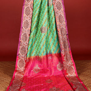 Green embossed vastrakala silksaree with ogee patterns & stonework, contrast cutwork border & intricate stonework pallu