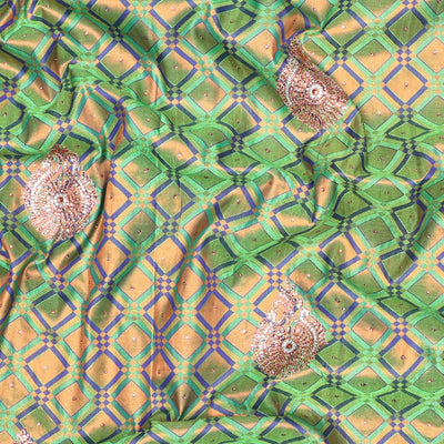 Green jacquard Vastrakala silksaree with stonework buttas, contrast cutwork border & intricate stonework pallu