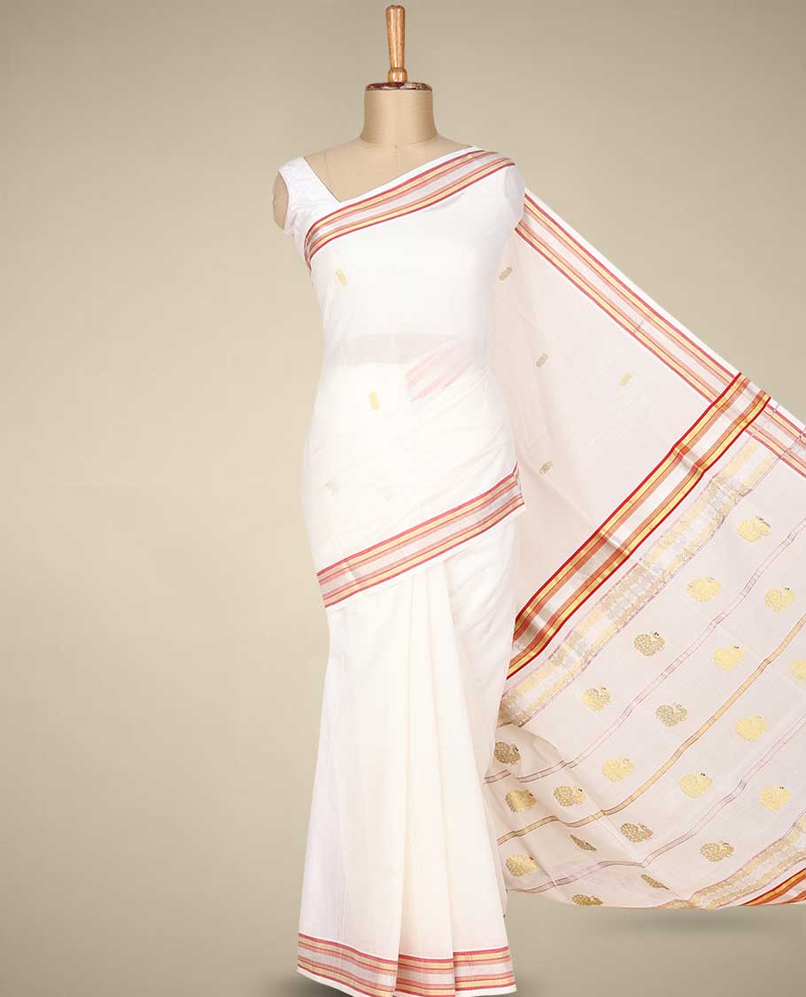 Cream kerala saree with zari buttas on its body, zari border & pallu features peacock designs