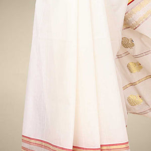 Cream kerala saree with zari buttas on its body, zari border & pallu features peacock designs