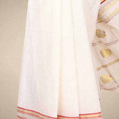Cream kerala saree with zari buttas on its body, zari border & pallu features peacock designs