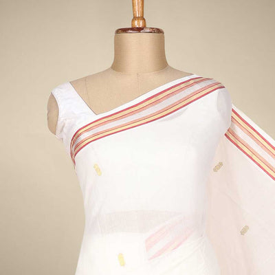 Cream kerala saree with zari buttas on its body, zari border & pallu features peacock designs