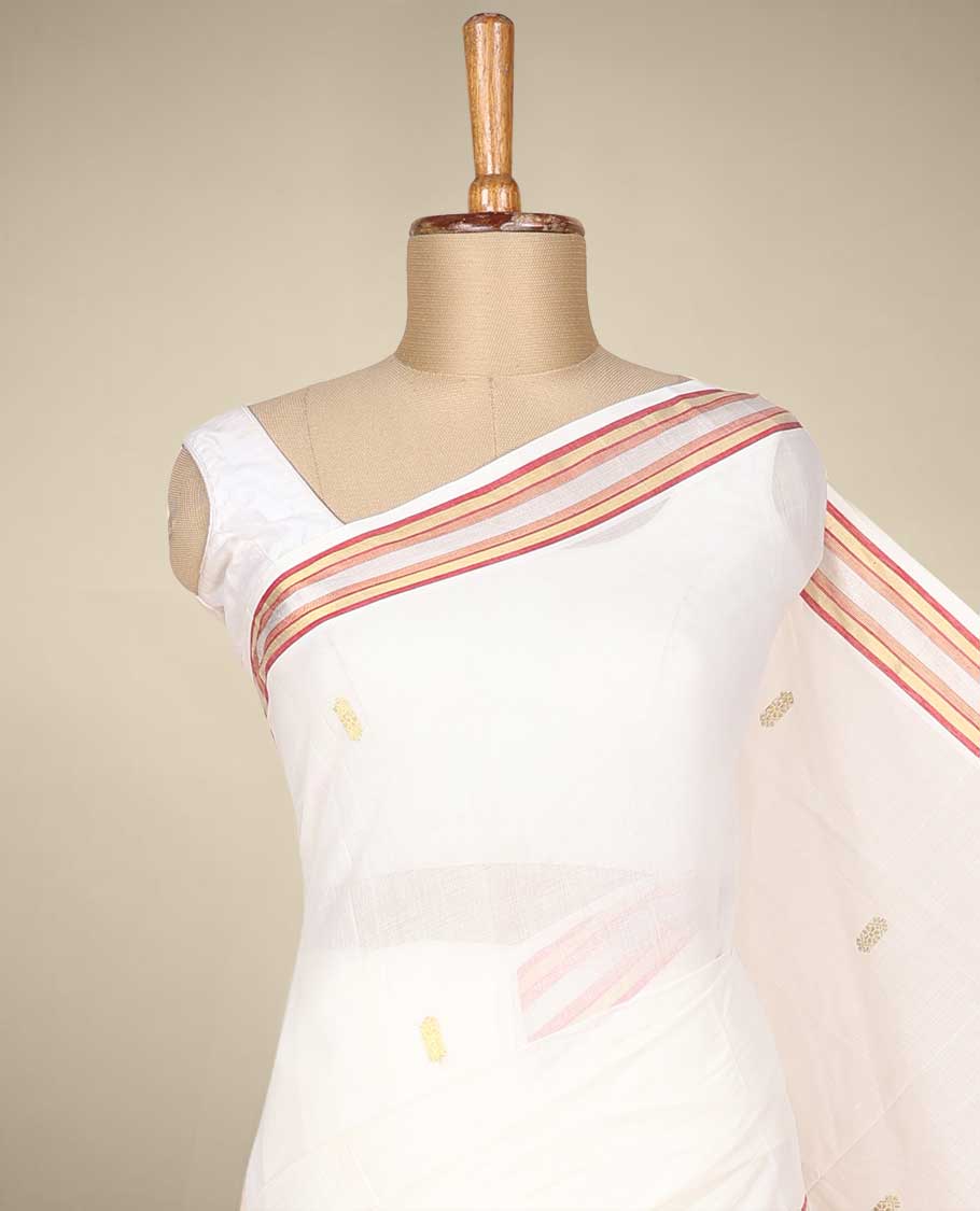 Cream kerala saree with zari buttas on its body, zari border & pallu features peacock designs
