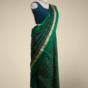 Green geometric printed silk saree with contrast intricate design border