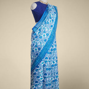 Blue floral vine design printed silk saree with contrast striped zari border