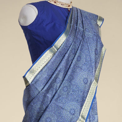 Blue floral kaleidoscopic design printed silk saree with contrast intricate zari border