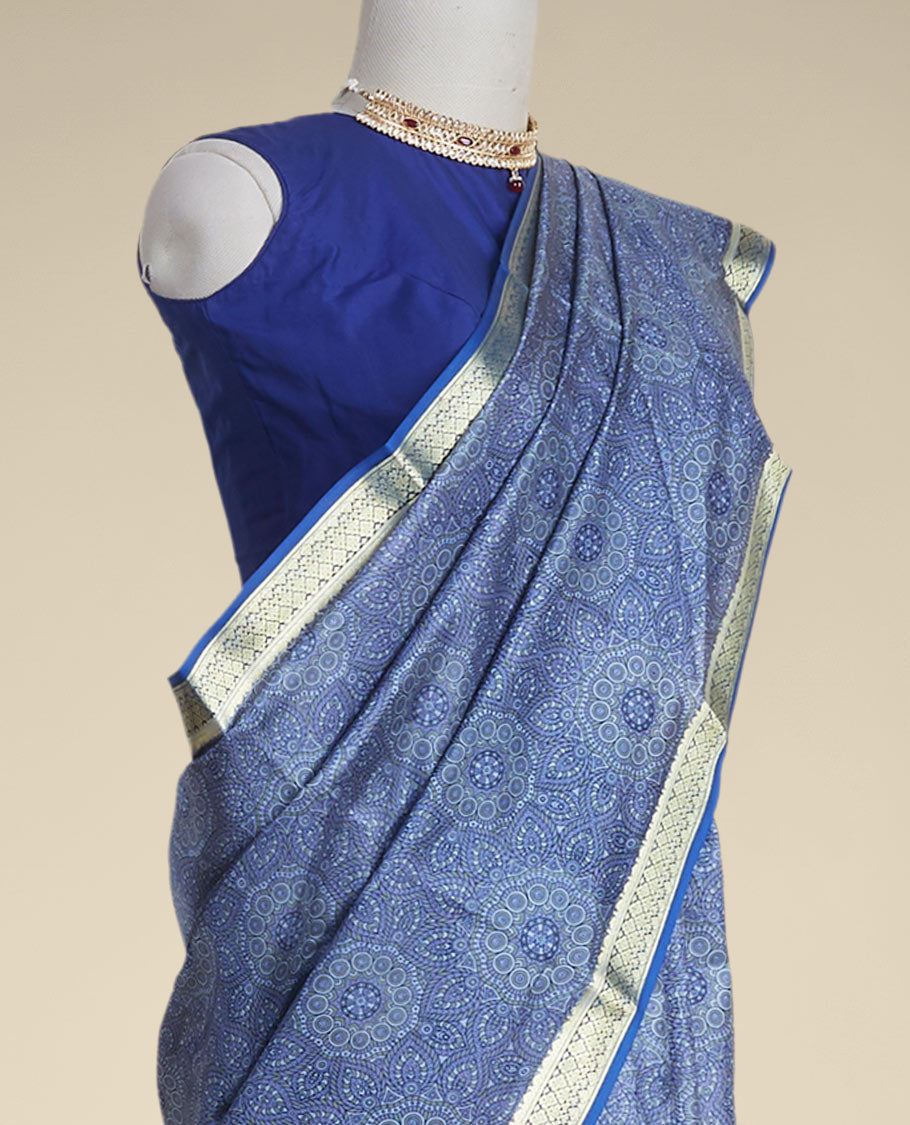 Blue floral kaleidoscopic design printed silk saree with contrast intricate zari border
