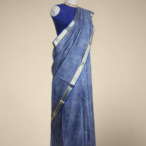 Blue floral kaleidoscopic design printed silk saree with contrast intricate zari border