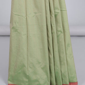 Borderless pastel green aarani gift saree with unique buttas, contrast pallu of traditional designs