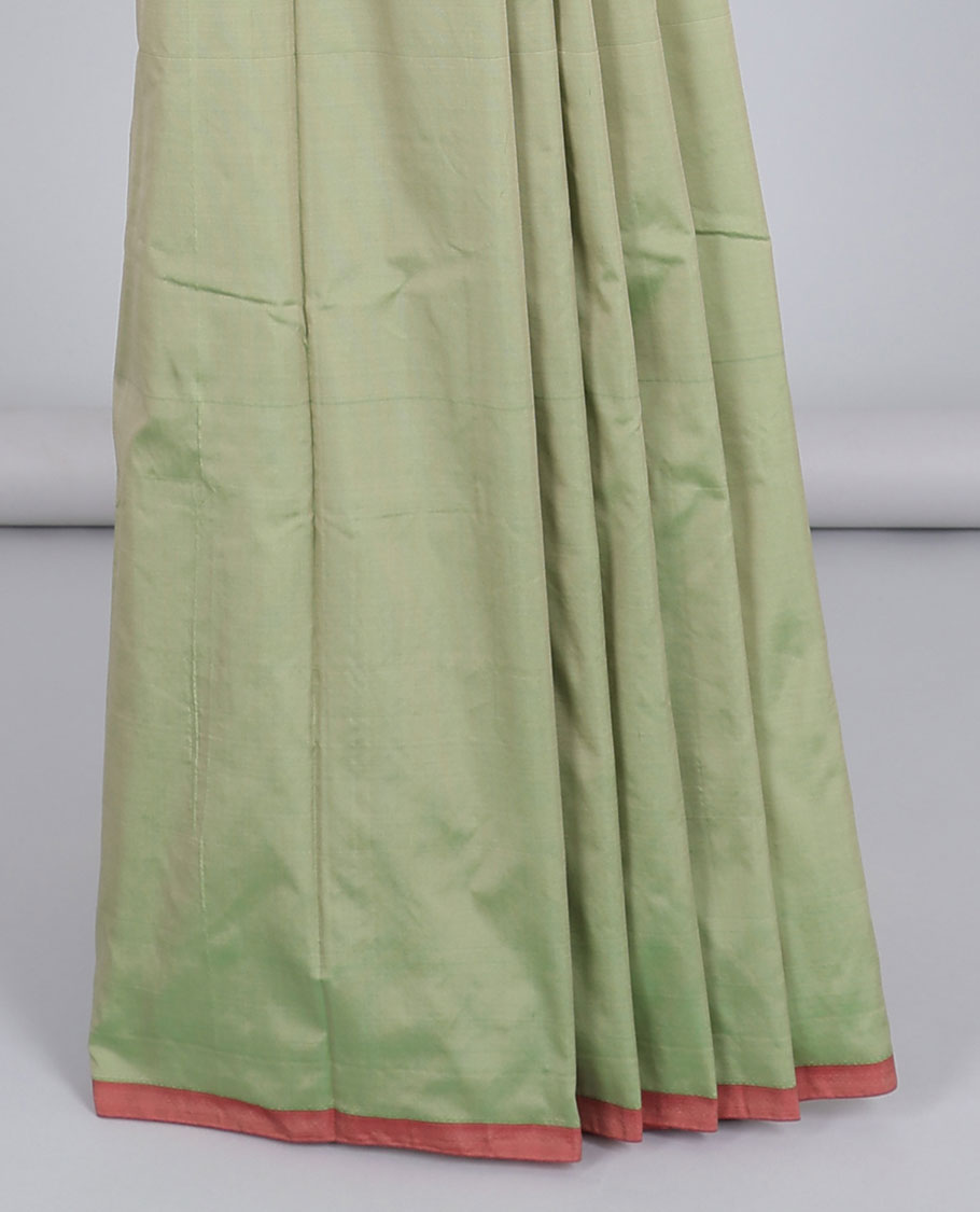 Borderless pastel green aarani gift saree with unique buttas, contrast pallu of traditional designs