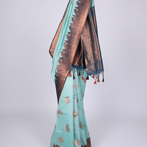 Pastel blue butter silk saree with zari buttas, contrast border of paisleys & peacock & ogee patterned pallu