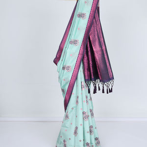 Celeste blue butter silk saree with floral buttas, contrast rose copper zari design border & intricate pallu