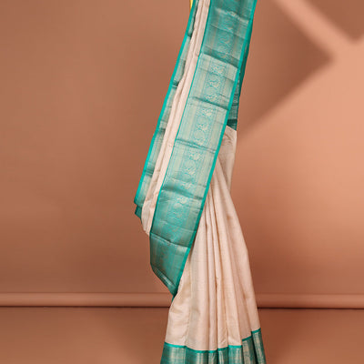 Cream striped silk saree with contrast border of thilakam mokku, mayil kann, mayil design & intricate zari design pallu