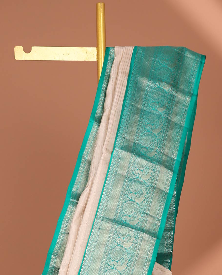 Cream striped silk saree with contrast border of thilakam mokku, mayil kann, mayil design & intricate zari design pallu
