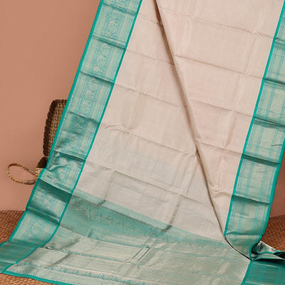 Cream striped silk saree with contrast border of thilakam mokku, mayil kann, mayil design & intricate zari design pallu