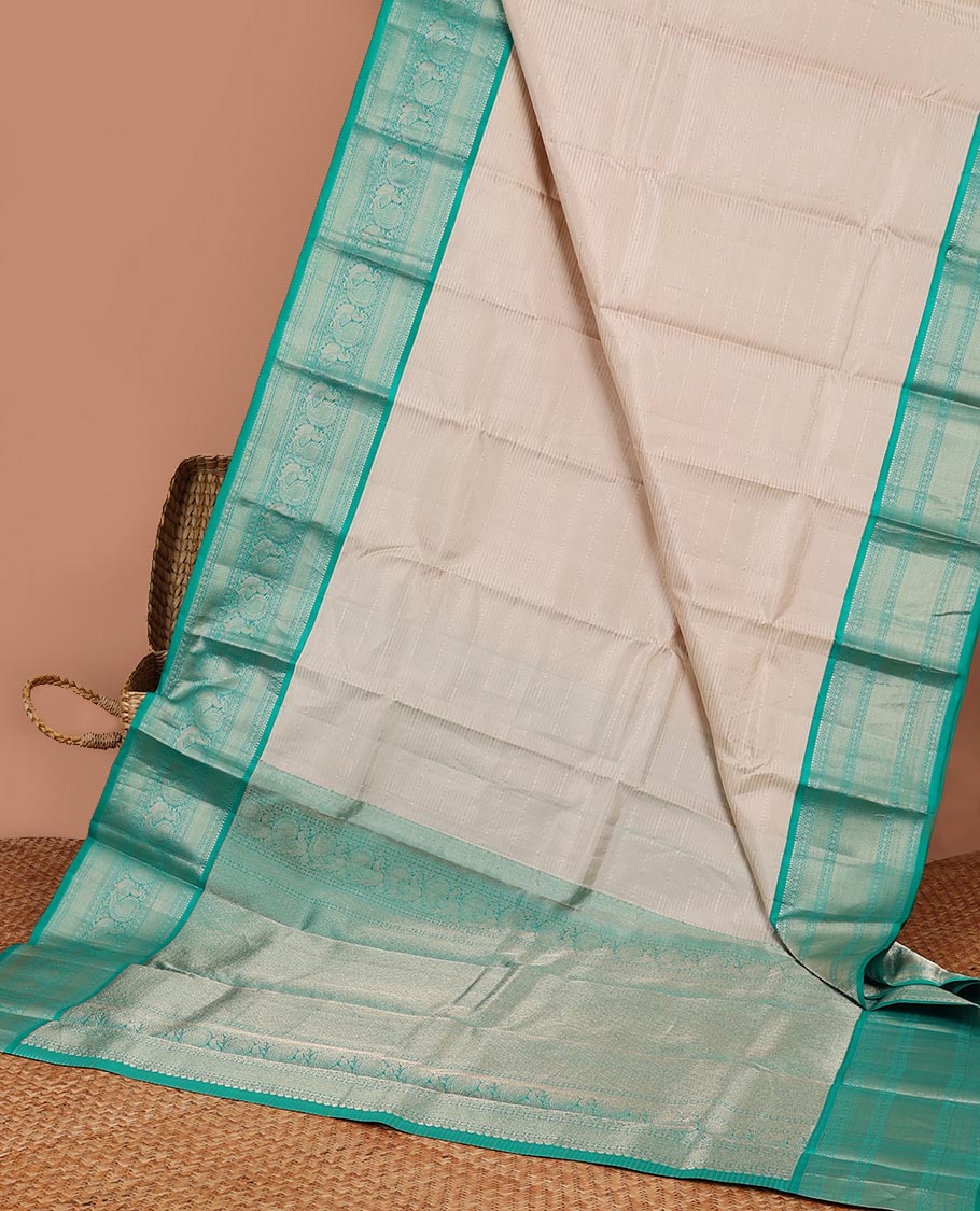 Cream striped silk saree with contrast border of thilakam mokku, mayil kann, mayil design & intricate zari design pallu