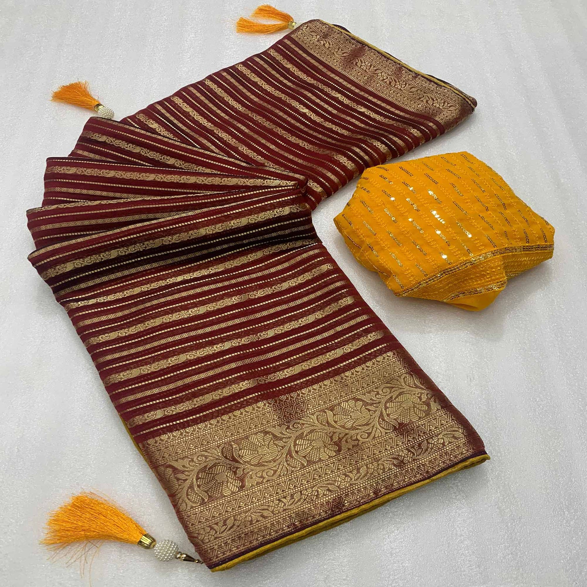 Maroon Woven Georgette Saree With Tassels