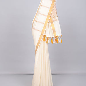 Cream kerala saree with zari designs, zari border & pallu of paisley designs in zari