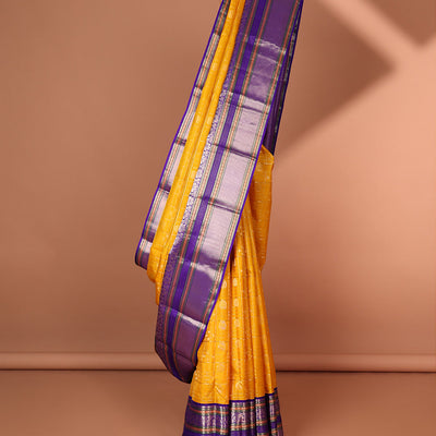 Yellow buttas enclosed with checked silk saree with contrast border of muthu,paun,banaras deisgn & intricate zari pallu