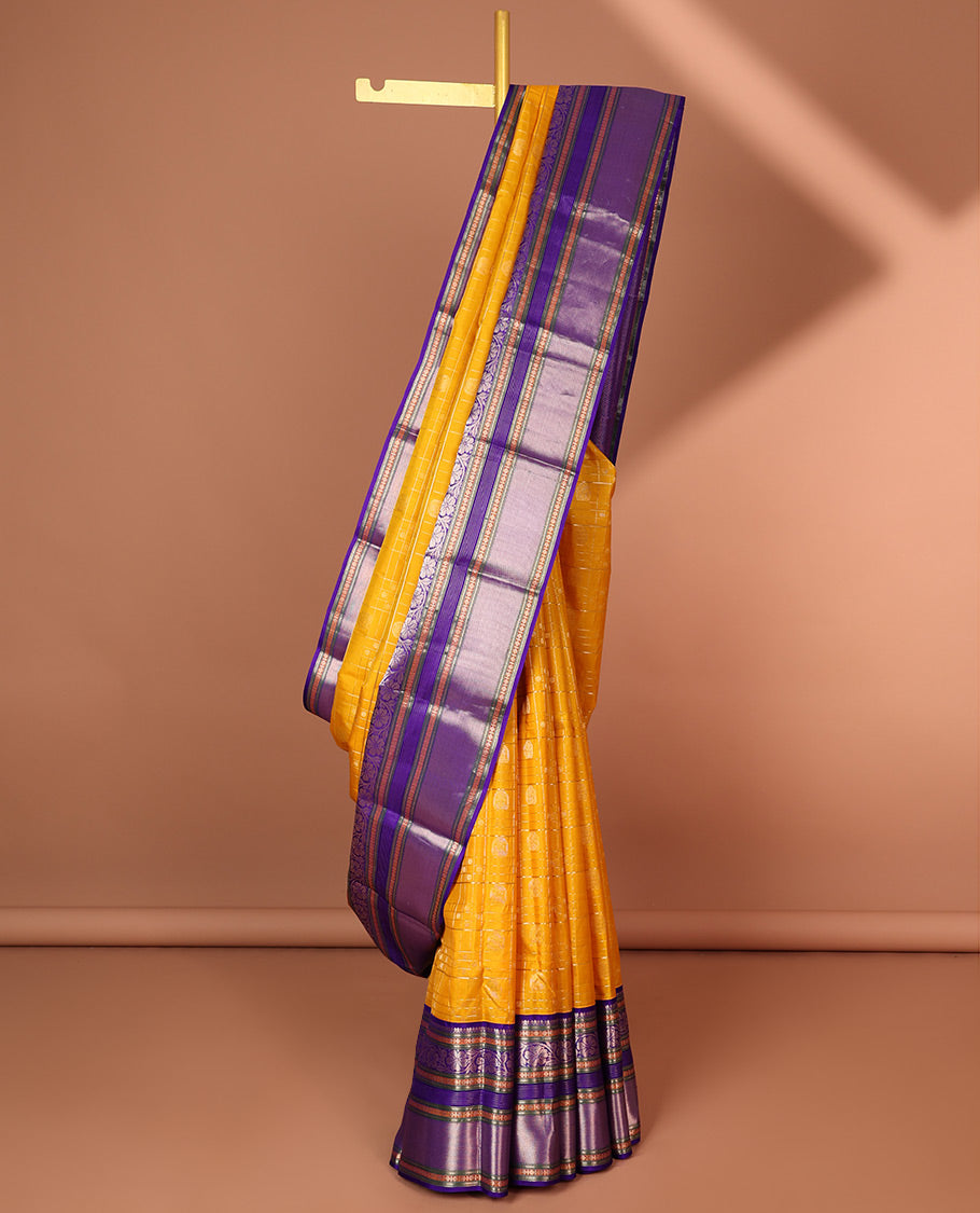 Yellow buttas enclosed with checked silk saree with contrast border of muthu,paun,banaras deisgn & intricate zari pallu