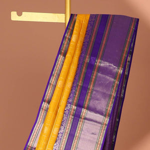 Yellow buttas enclosed with checked silk saree with contrast border of muthu,paun,banaras deisgn & intricate zari pallu