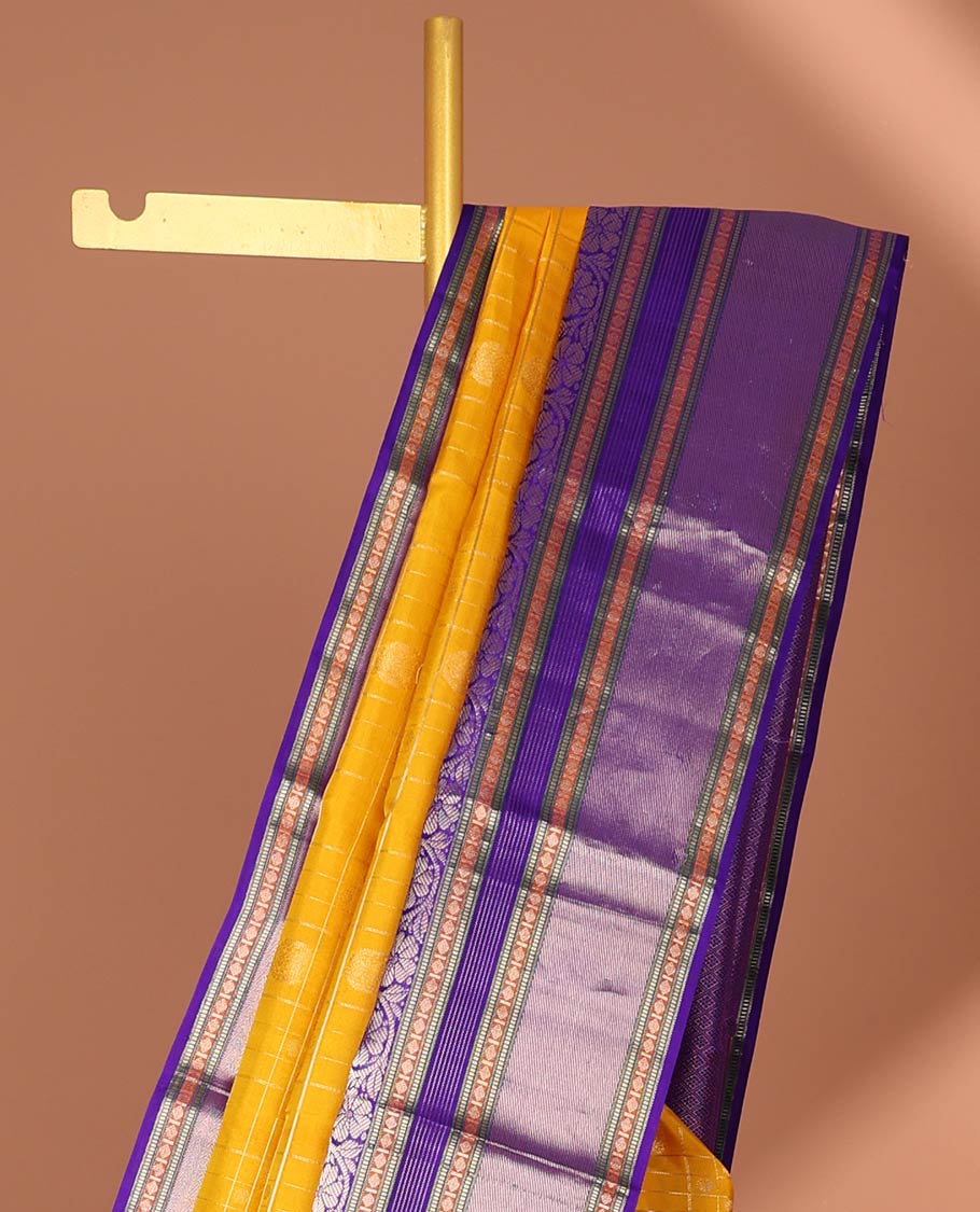 Yellow buttas enclosed with checked silk saree with contrast border of muthu,paun,banaras deisgn & intricate zari pallu