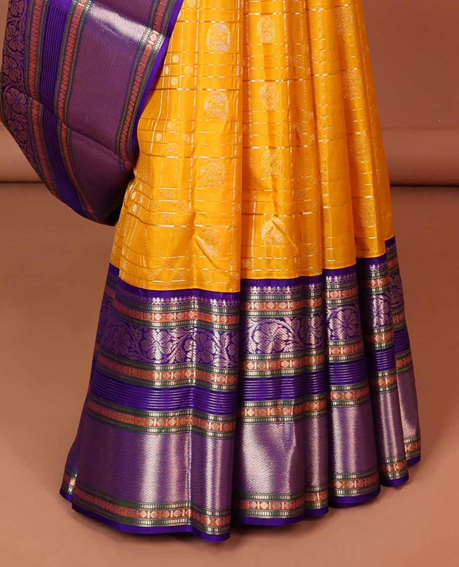 Yellow buttas enclosed with checked silk saree with contrast border of muthu,paun,banaras deisgn & intricate zari pallu
