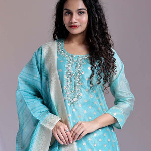 Blue readymade suit,zari buttas & embroidery round-neck tissue top,plain pants & dupatta of floral & chevron print