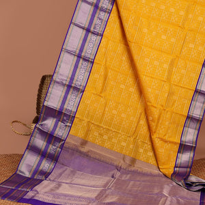Yellow buttas enclosed with checked silk saree with contrast border of muthu,paun,banaras deisgn & intricate zari pallu