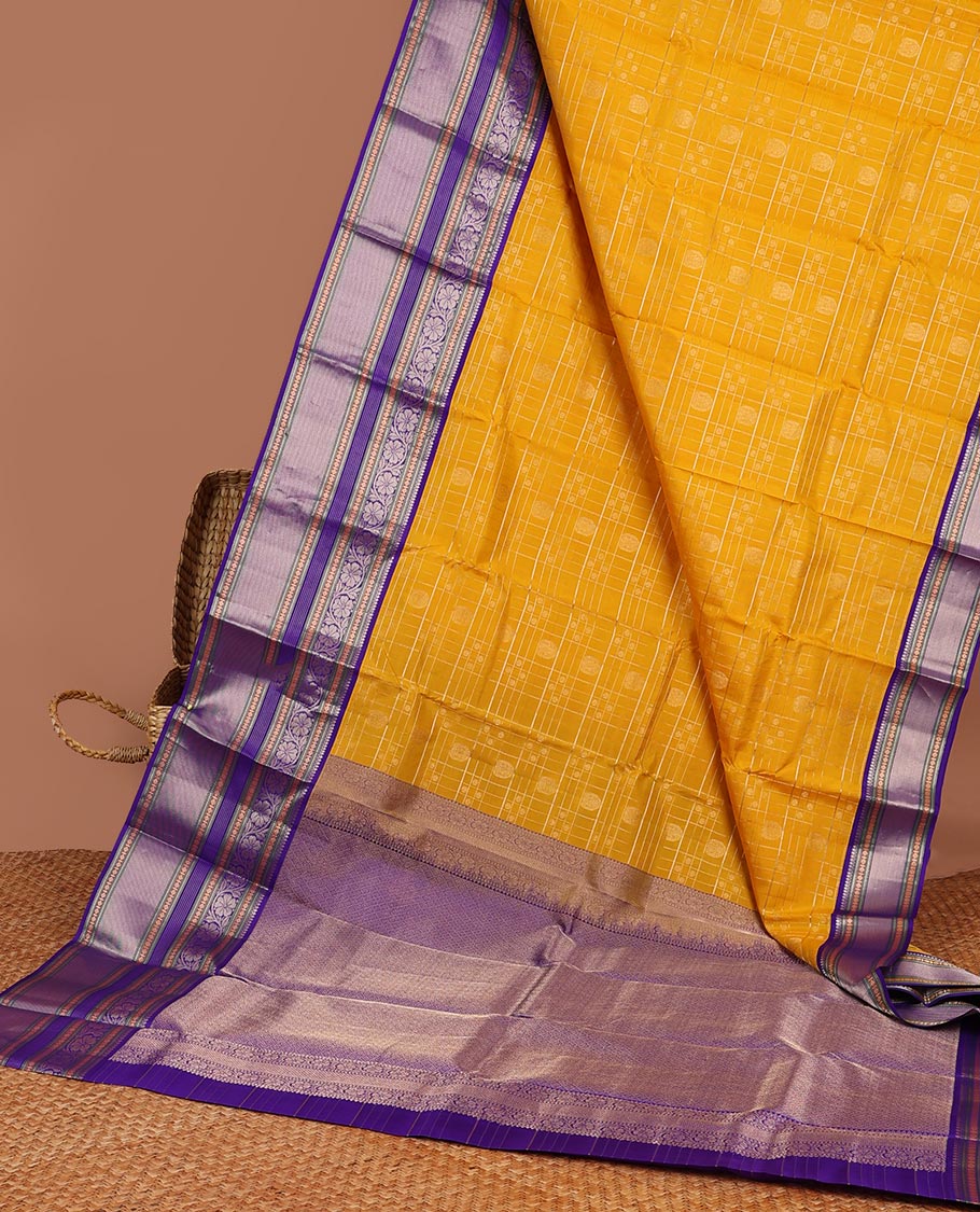Yellow buttas enclosed with checked silk saree with contrast border of muthu,paun,banaras deisgn & intricate zari pallu