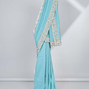 Blue plain design crushed tissue saree, contrast floral & bird embroidery border