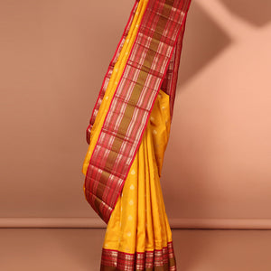 Yellow leaf buttas silk saree with contrast border of thilakam mokku, muthu, paun design & pallu of jaal design