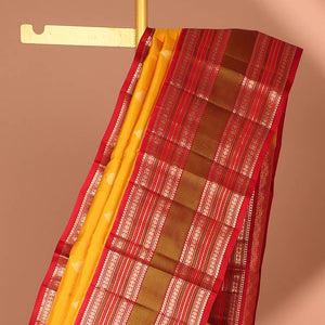 Yellow leaf buttas silk saree with contrast border of thilakam mokku, muthu, paun design & pallu of jaal design