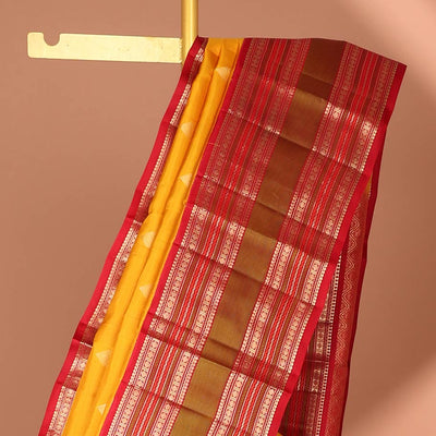 Yellow leaf buttas silk saree with contrast border of thilakam mokku, muthu, paun design & pallu of jaal design