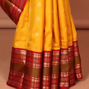 Yellow leaf buttas silk saree with contrast border of thilakam mokku, muthu, paun design & pallu of jaal design