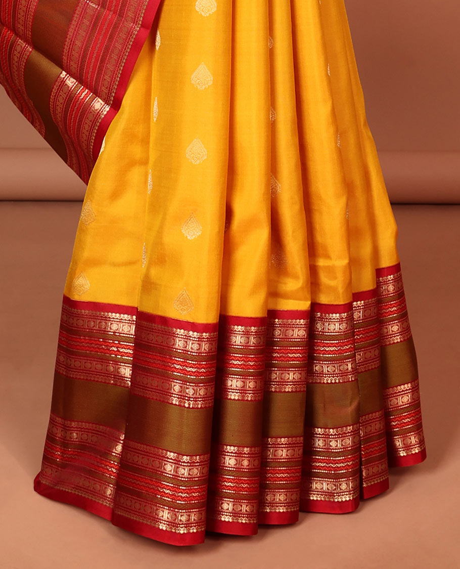 Yellow leaf buttas silk saree with contrast border of thilakam mokku, muthu, paun design & pallu of jaal design