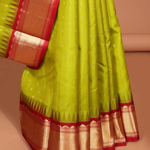 Green buttas silk saree, contrast border of rekku,banaras & jaal & pallu of ogee pattern