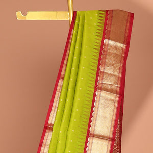 Green buttas silk saree, contrast border of rekku,banaras & jaal & pallu of ogee pattern