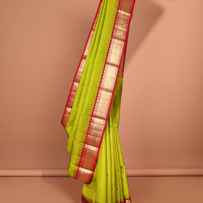 Green buttas silk saree, contrast border of rekku,banaras & jaal & pallu of ogee pattern