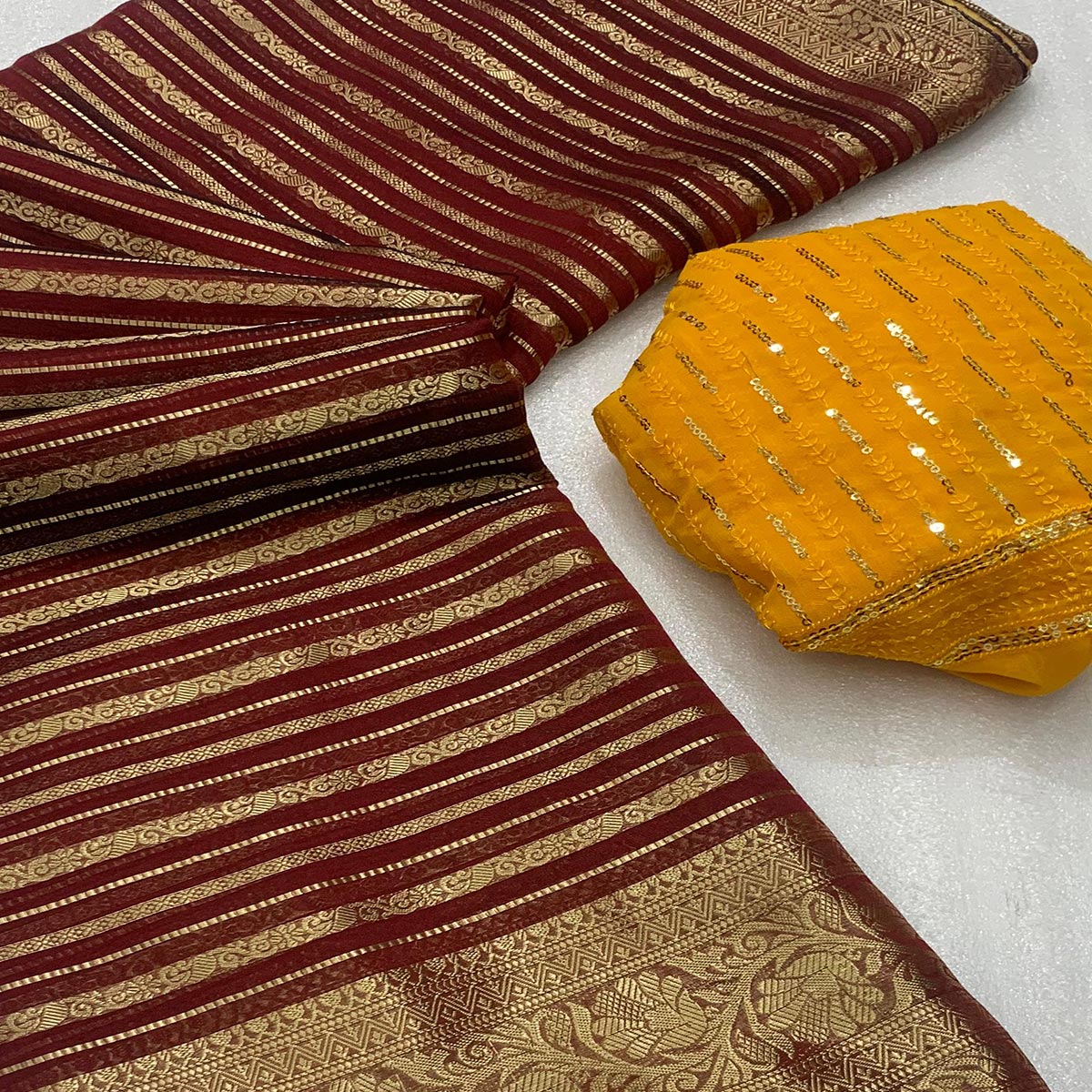 Maroon Woven Georgette Saree With Tassels