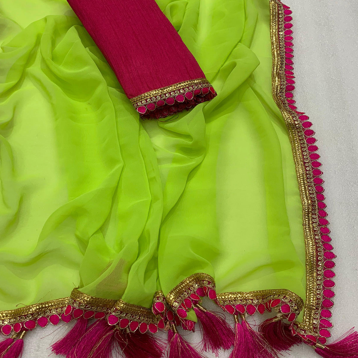 green-solid-georgette-saree-with-embroidered-lace-border-tassels