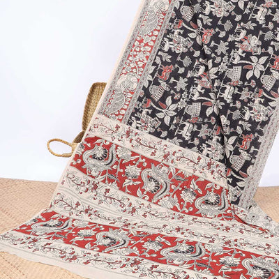 Black village theme machine-printed kalamkari cotton saree, contrast peacock border & intricate pallu