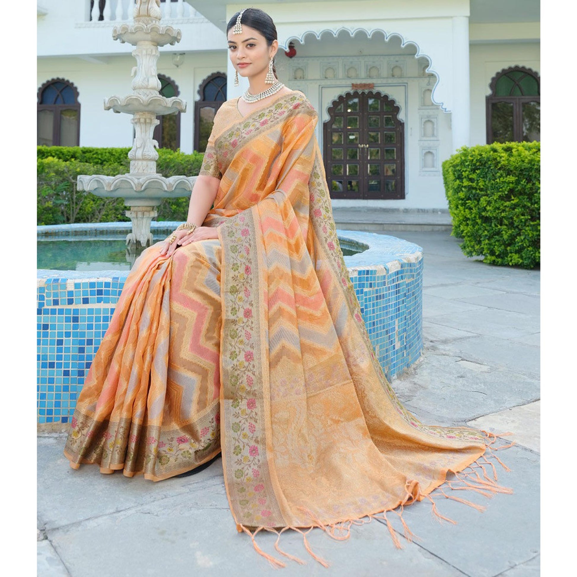 Light Orange Woven Organza Saree With Tassels