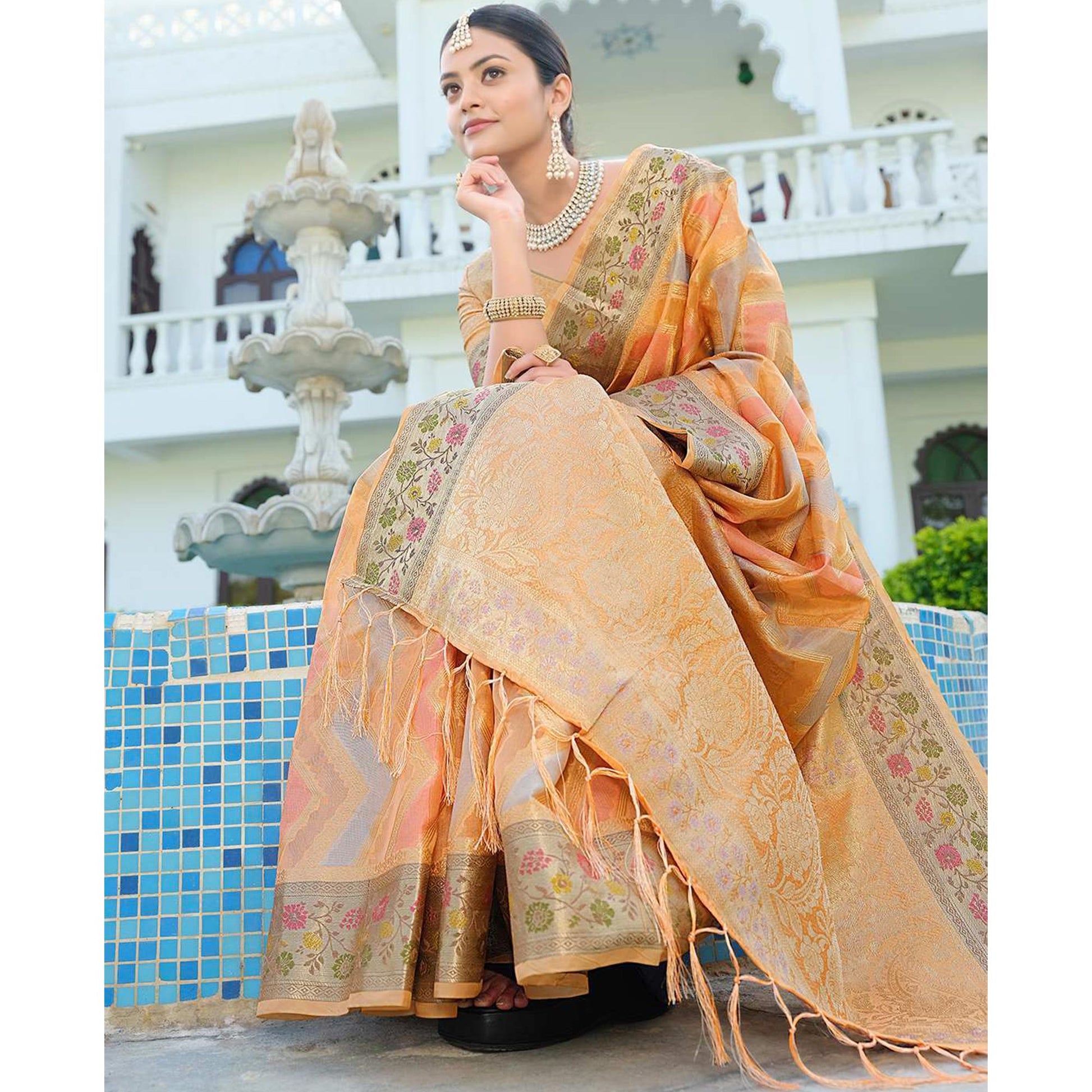 Light Orange Woven Organza Saree With Tassels
