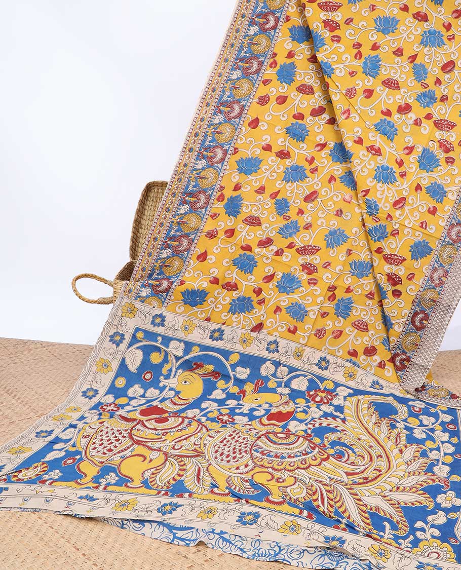 Yellow floral vine machine-printed kalamkari cotton saree, contrast tree motifs border & peacock pallu