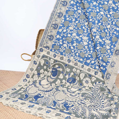 Blue floral machine-printed kalamkari cotton saree, contrast tree motifs border & peacock pallu